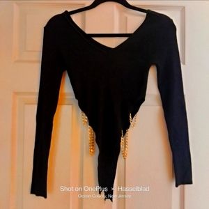 Long sleeve shirt with decorative gold chains and below snap for security